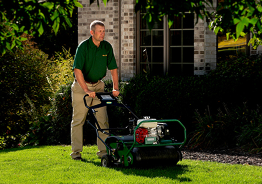 Weed Man technician aerating lawn